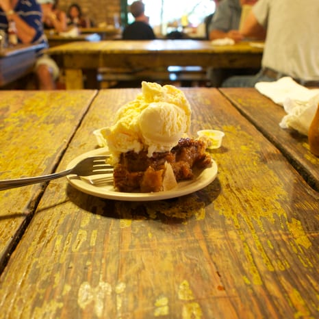 A slice of pecan pie with a dense nut filling