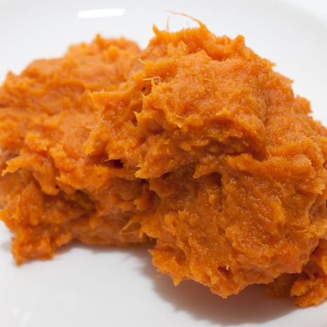 A bowl of mashed orange sweet potatoes