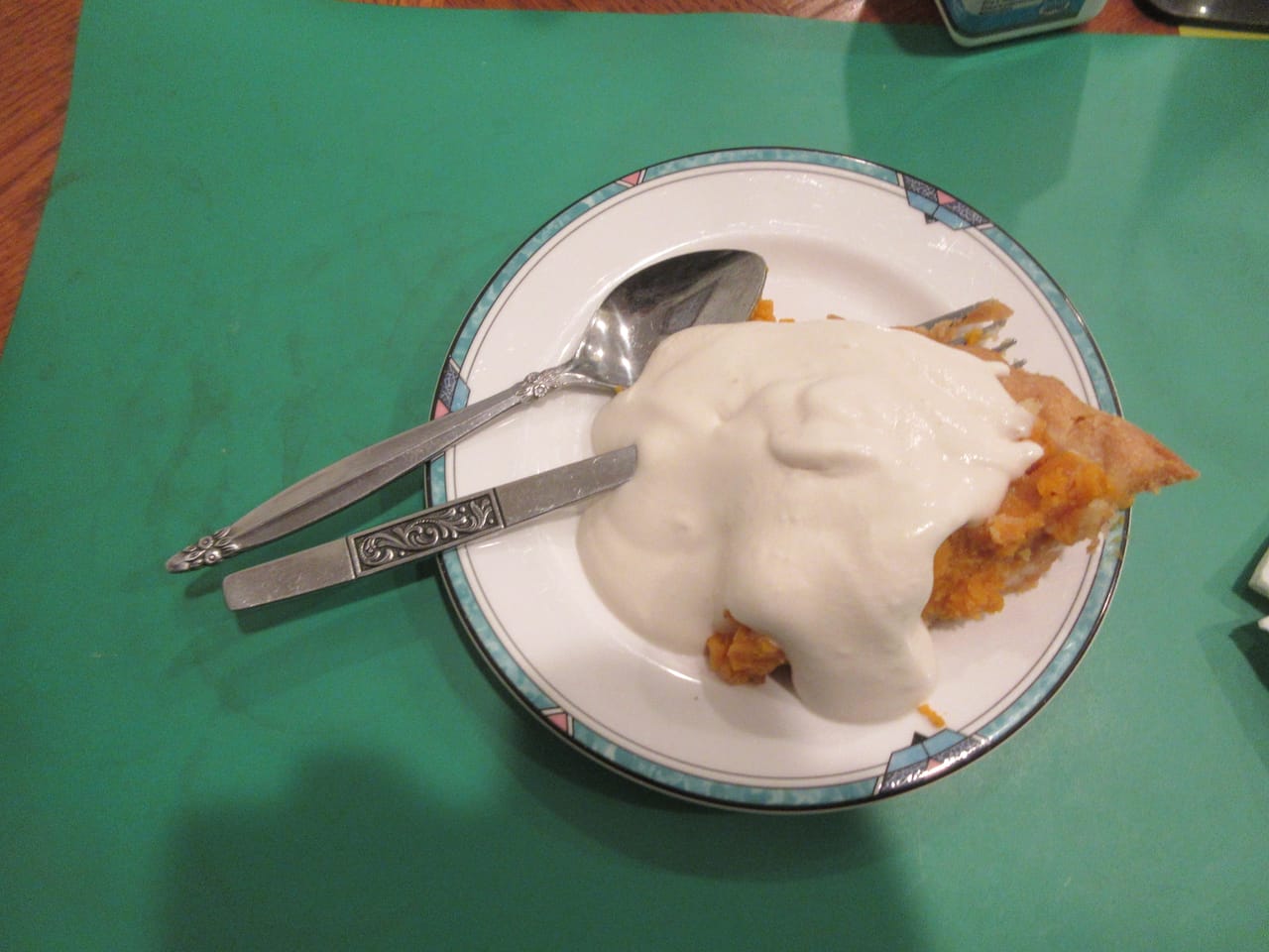 A slice of pumpkin pie with whipped cream