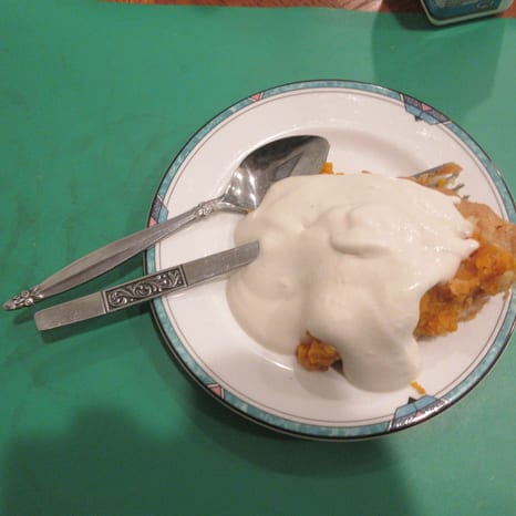 A slice of pumpkin pie with whipped cream
