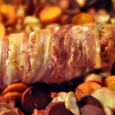 Sliced pork tenderloin with roasted root vegetables and bacon