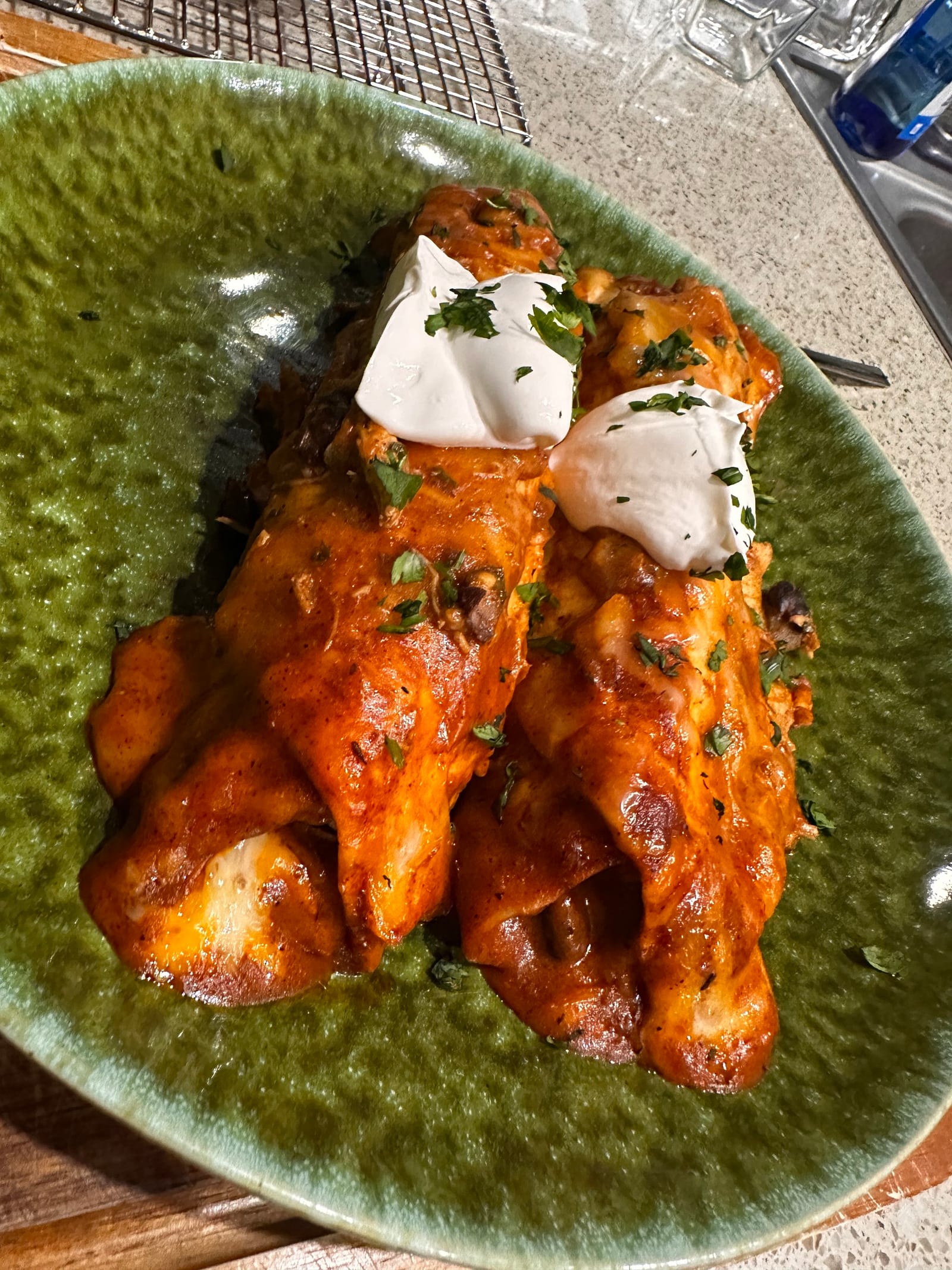 Baked cheese enchiladas with sauce and crema