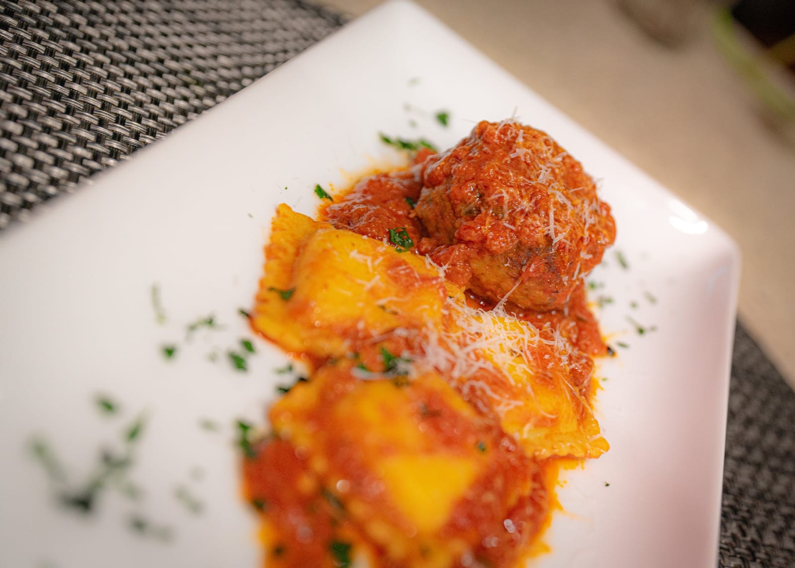 Meatballs simmered in marinara on ravioli