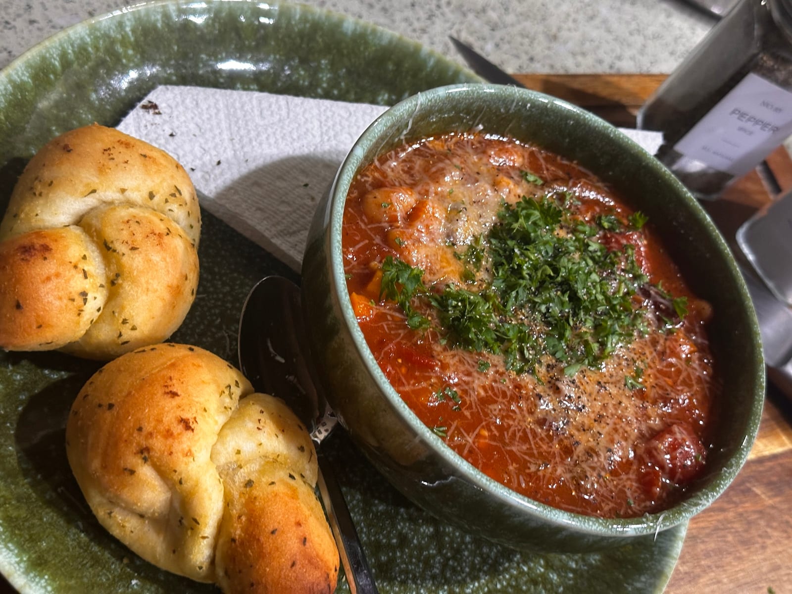 Baked garlic knots beside white-bean chili